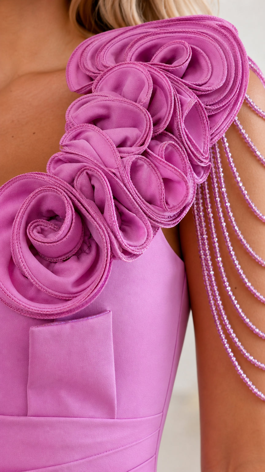 Closeup of shoulder rose appliques and beaded fringe detail