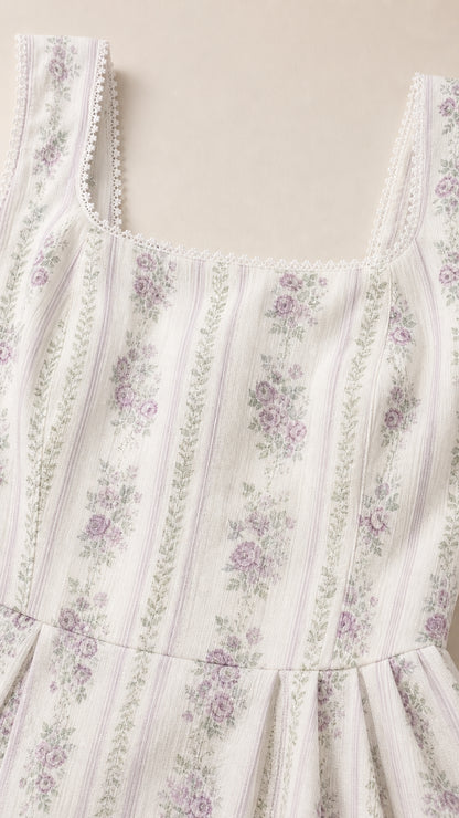 Close-up of white floral dress fabric and square neckline with lace trim