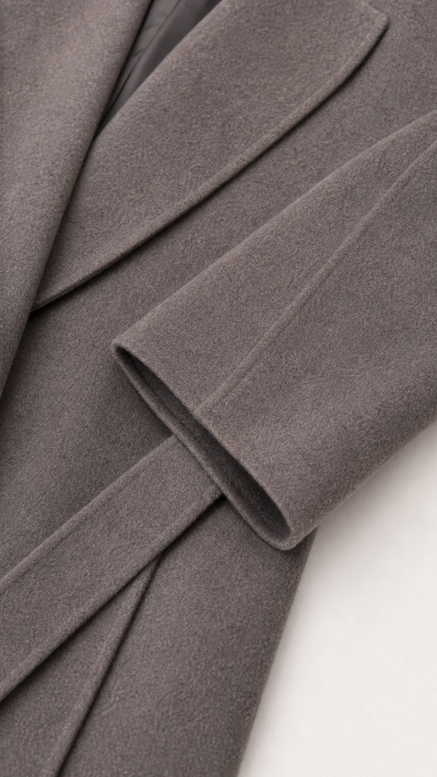 Close-up detail of grey brushed fabric cuff and belt
