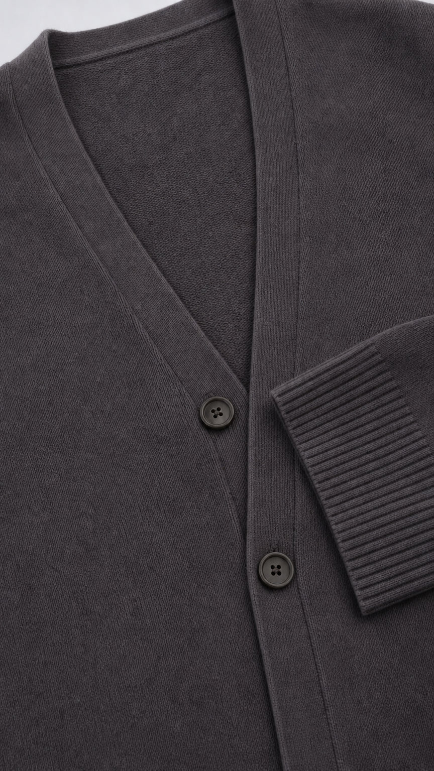 Close up view of Charcoal Grey cardigan showing V-neck, buttons, and ribbed cuff texture