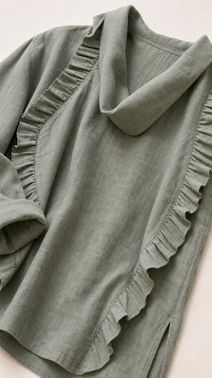 Close-up detail of sage green fabric, cowl neck, and ruffles
