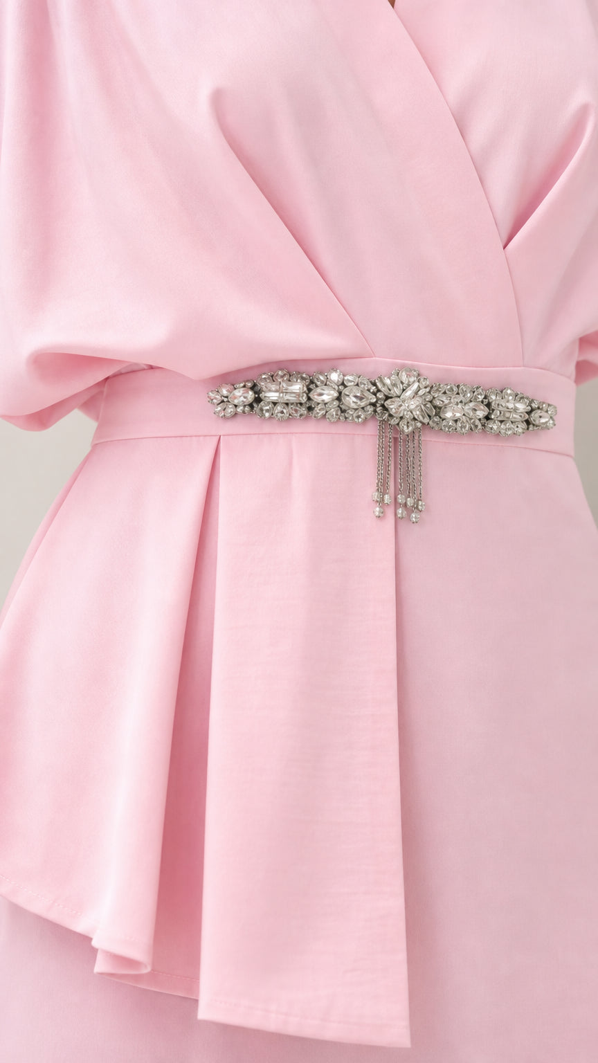 Close-up detail of crystal belt and pleated peplum waist accent on Light Pink dress
