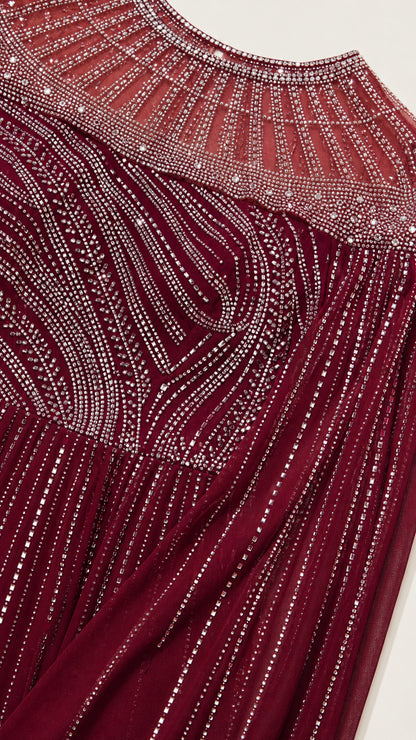 Close-up detail of rhinestone and bead embellishment on neckline