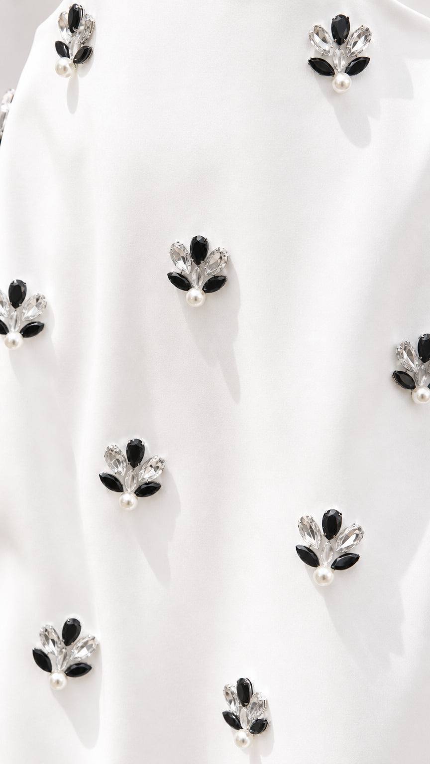 Close-up detail of crystal floral embellishments on woven fabric