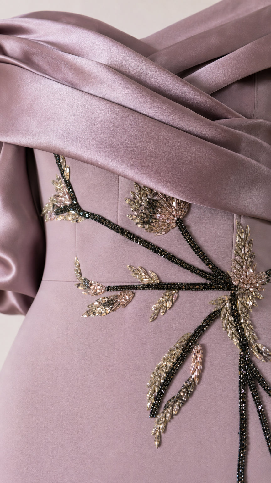 Close-up of beaded floral embroidery and draped satin bodice