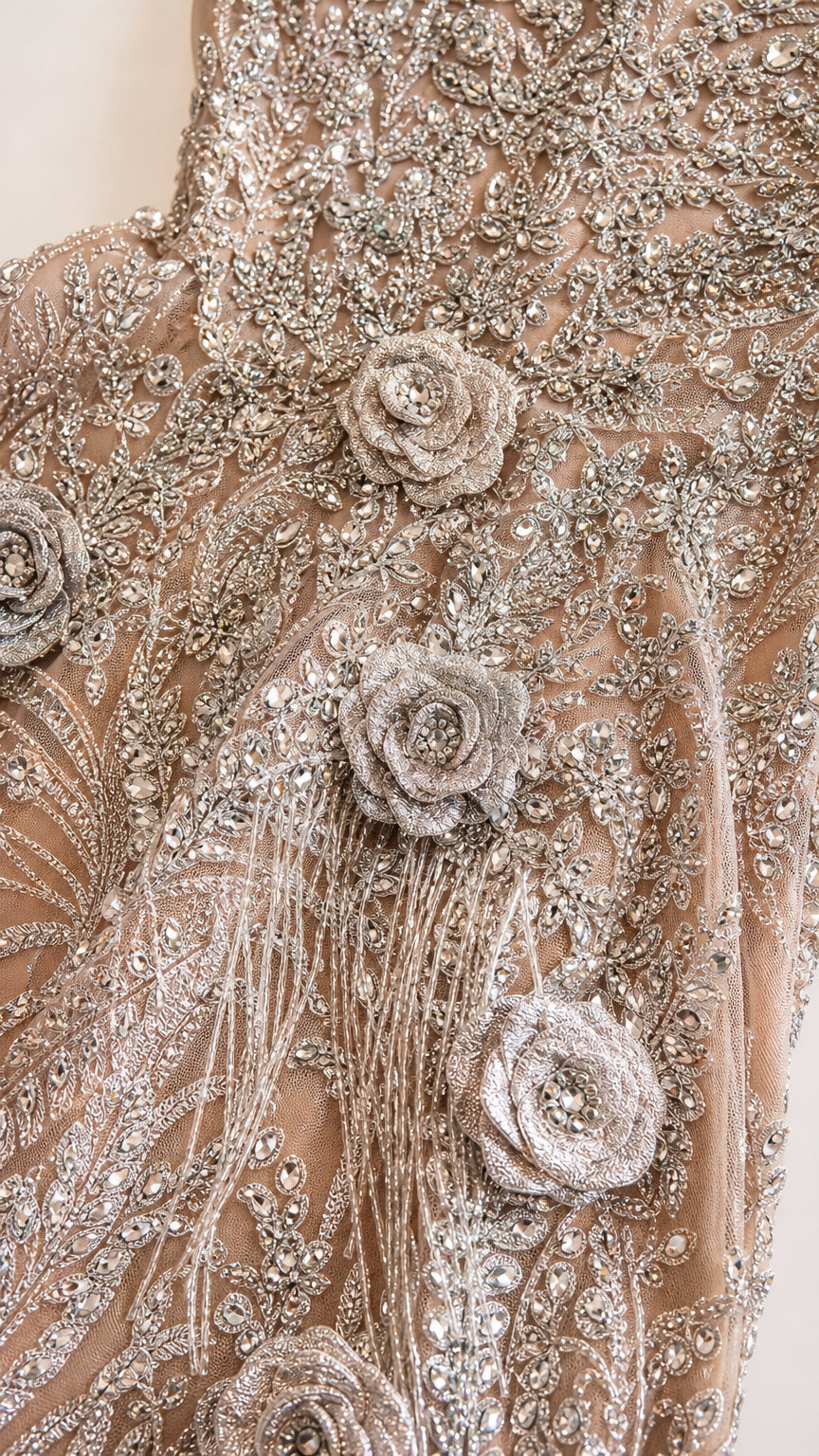 Close-up detail of silver embroidery, beads, and 3D floral rosettes