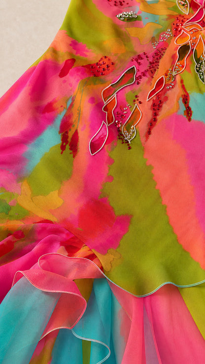 Close-up detail of watercolor print and beaded embroidery