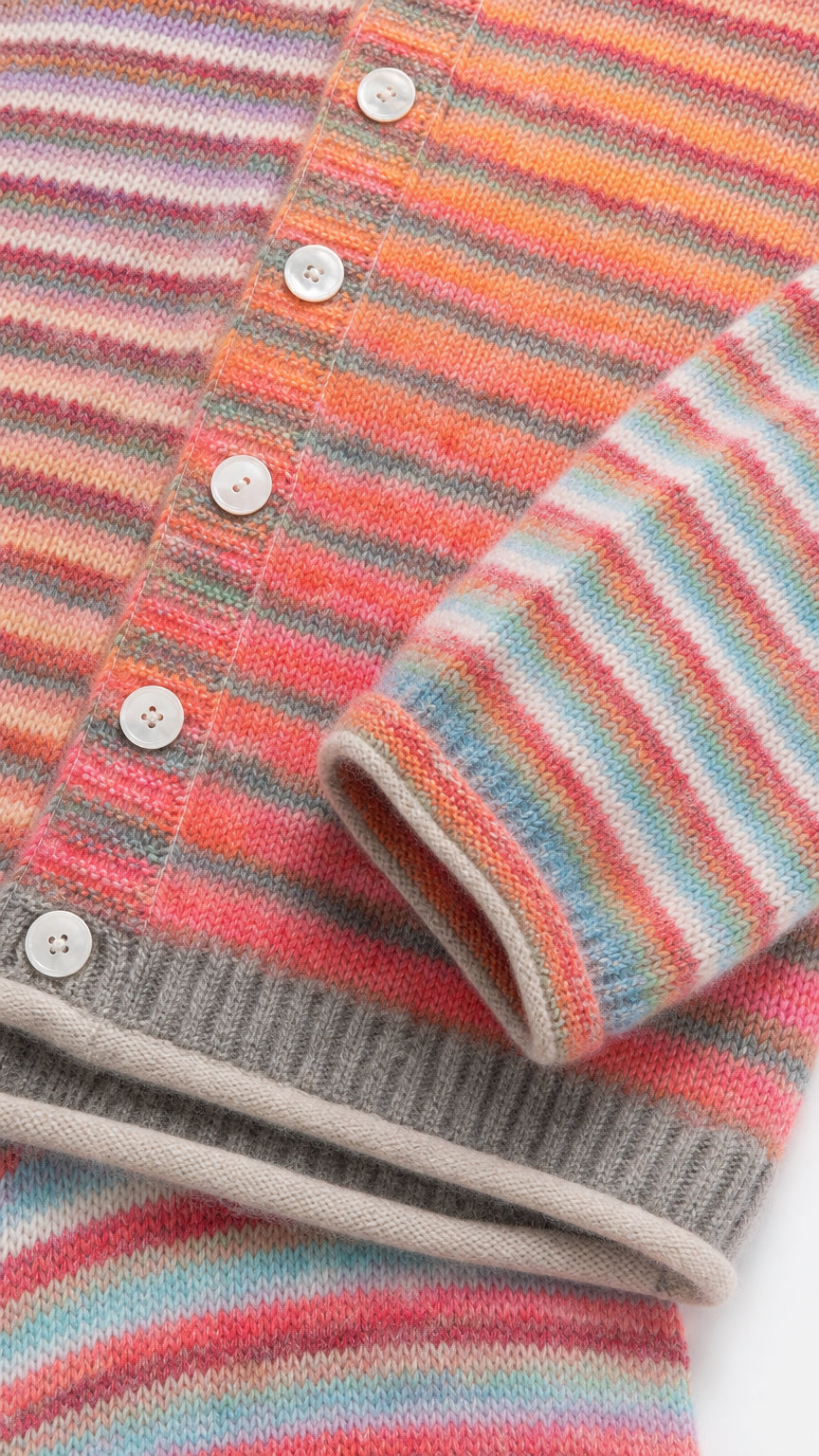 Close-up of Sunset Multi striped knit texture with white button placket and ribbed hem