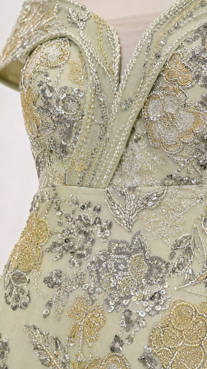 Close-up of floral and paisley-style silver and metallic embellishment on sage green gown fabric