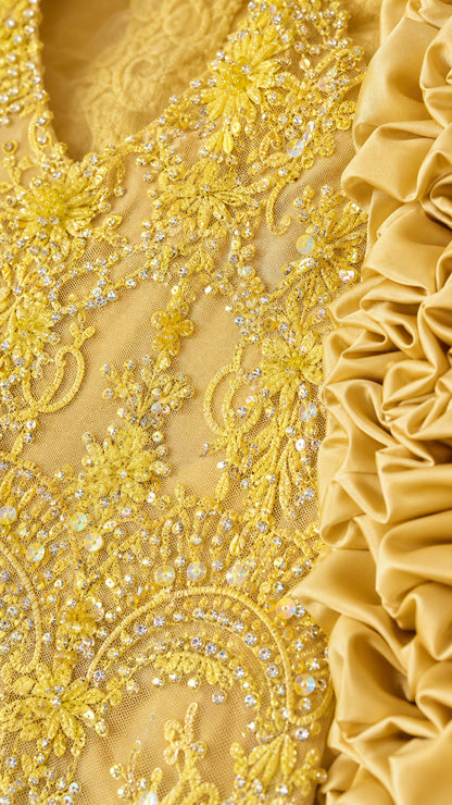 Close-up detail of yellow beadwork and lace texture