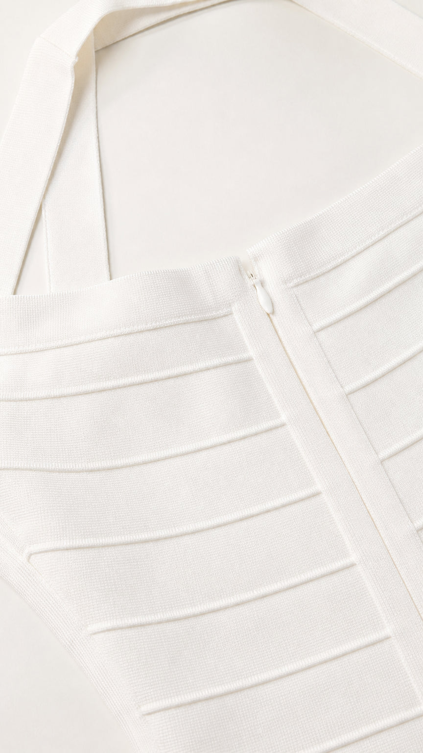 Close-up detail of white bandage dress texture and zipper