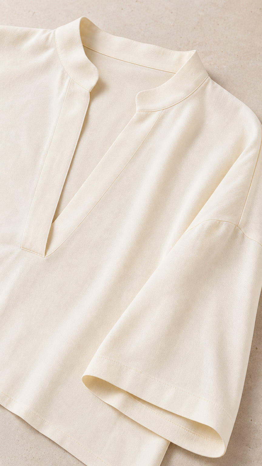 Close-up detail of cream tunic collar and sleeve cuff