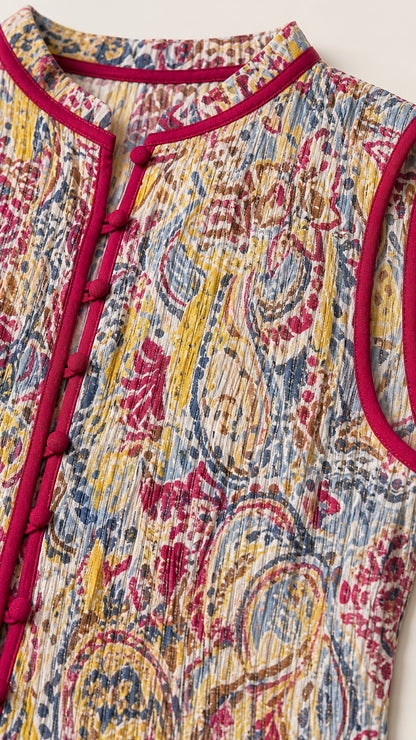Close-up detail of pleated texture and buttoned mandarin collar