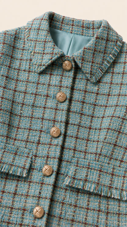 Close up view of tweed fabric texture, collar, and metallic buttons