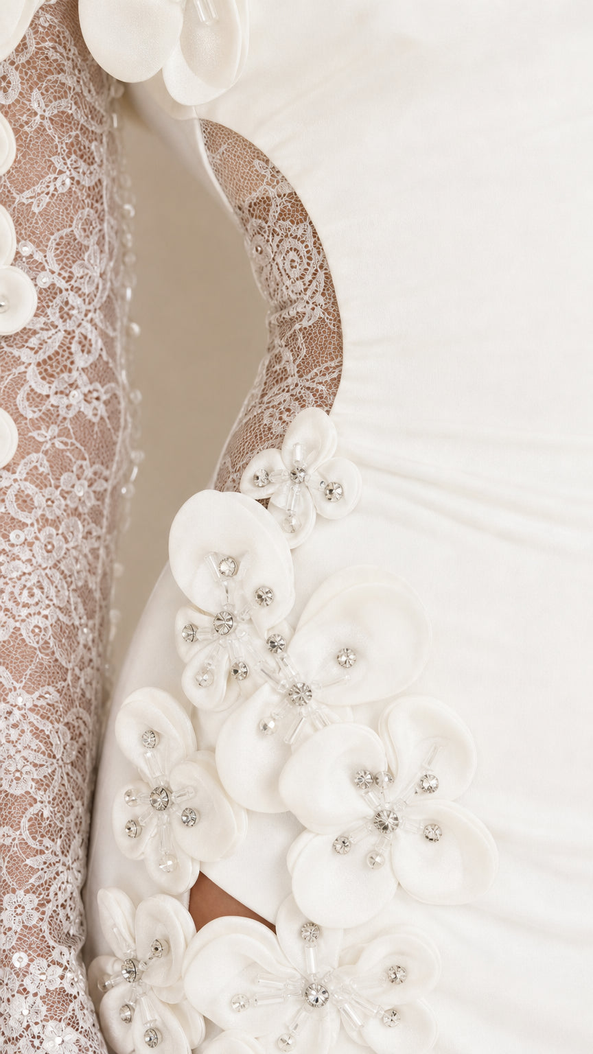 Close-up detail of 3D floral appliques and sheer lace sleeve