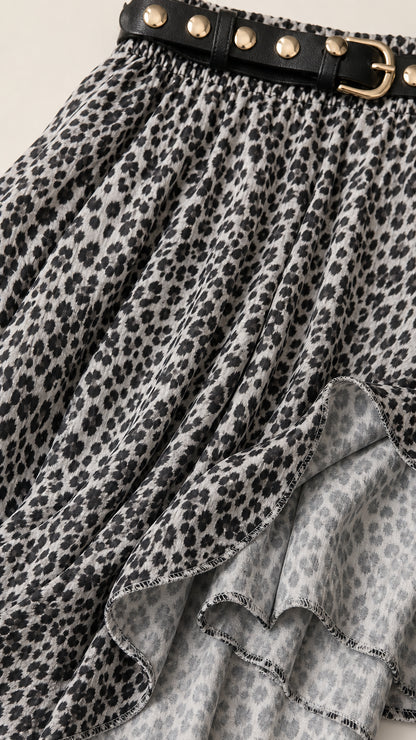 Close-up of leopard print fabric and studded belt detail