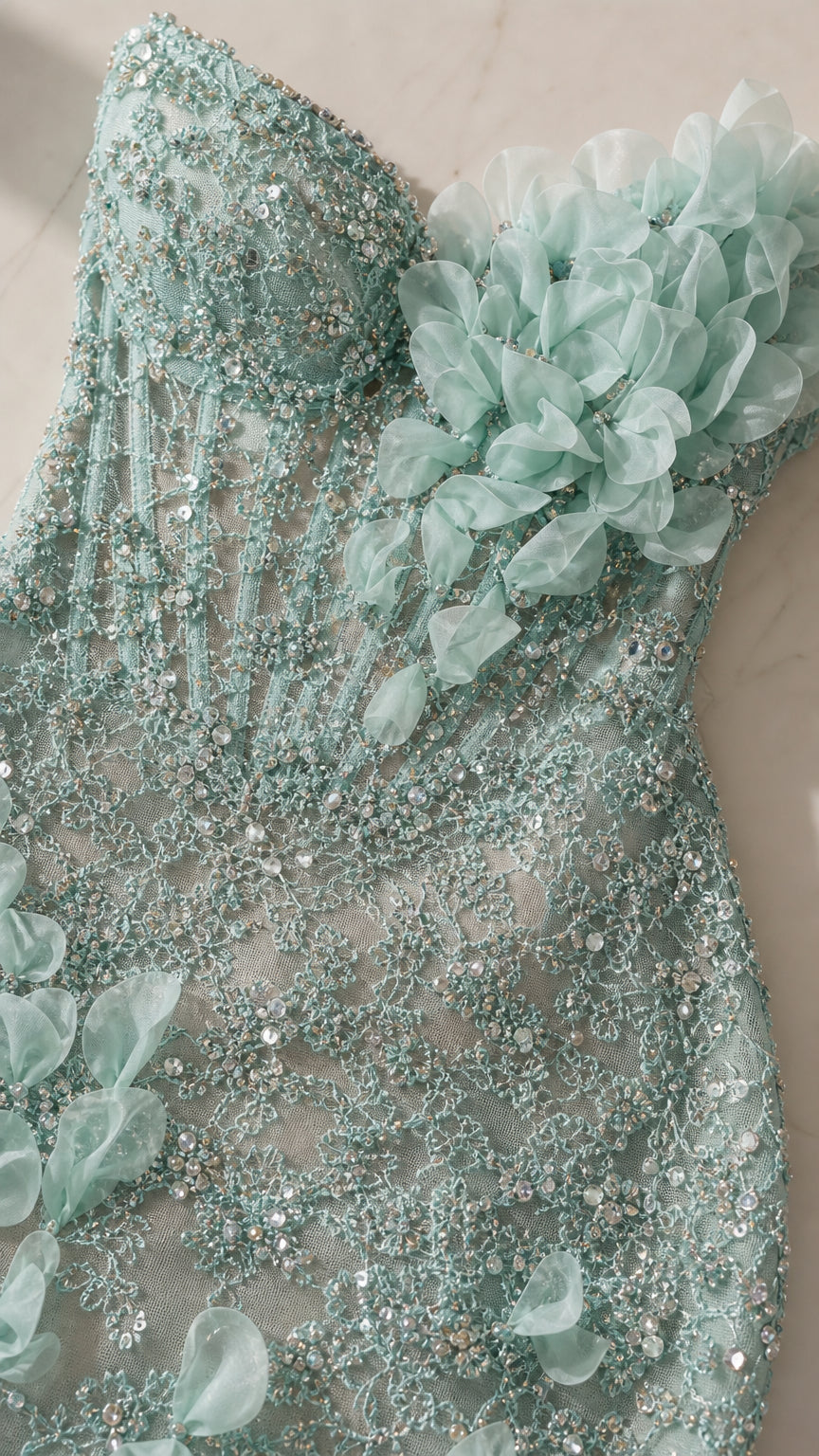 Close-up detail of sequin embroidery and 3D floral appliqués