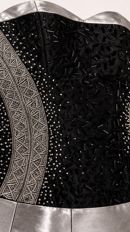 Close-up detail of beaded bodice and metallic trim