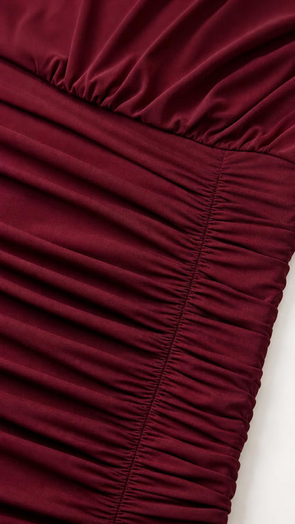 Close-up of texture and ruching detail on burgundy fabric