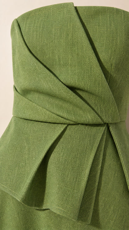 Close-up detail of structured bodice pleats and peplum waist