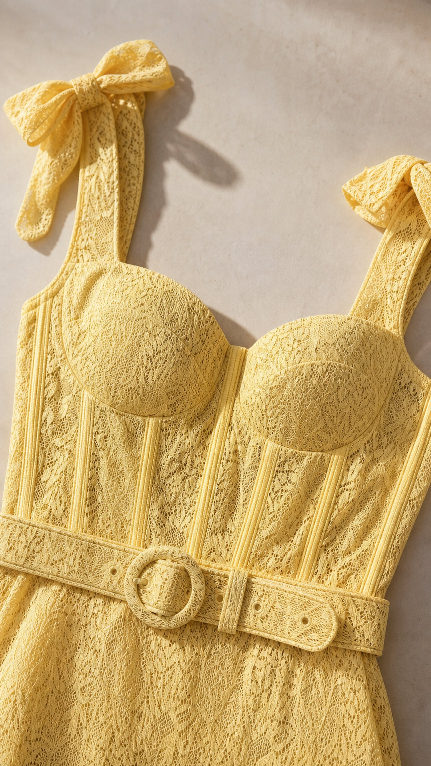 Close-up of bodice and bow straps on yellow lace dress