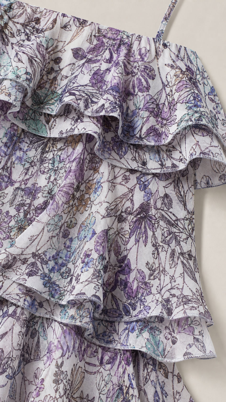 Close-up detail of layered ruffles and lavender floral print on lightweight fabric