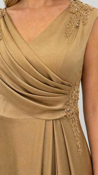 Close-up of V-neckline and shoulder embroidery on gold dress