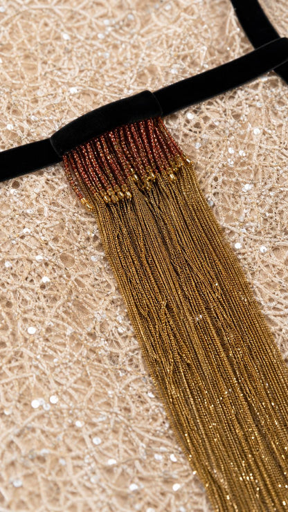 Close-up detail of beaded fringe belt and sequin texture