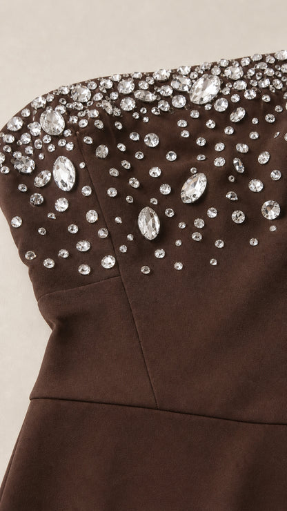 Close-up detail of rhinestone embellishments on brown bodice