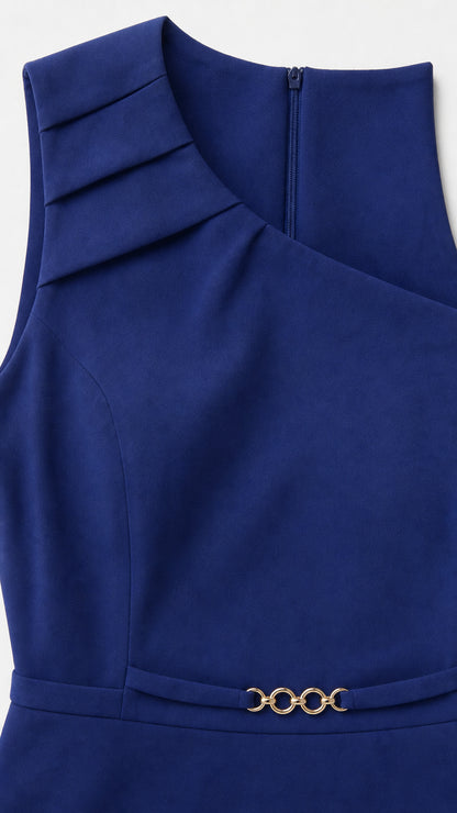 Close-up of neckline pleats and gold waist hardware on blue dress