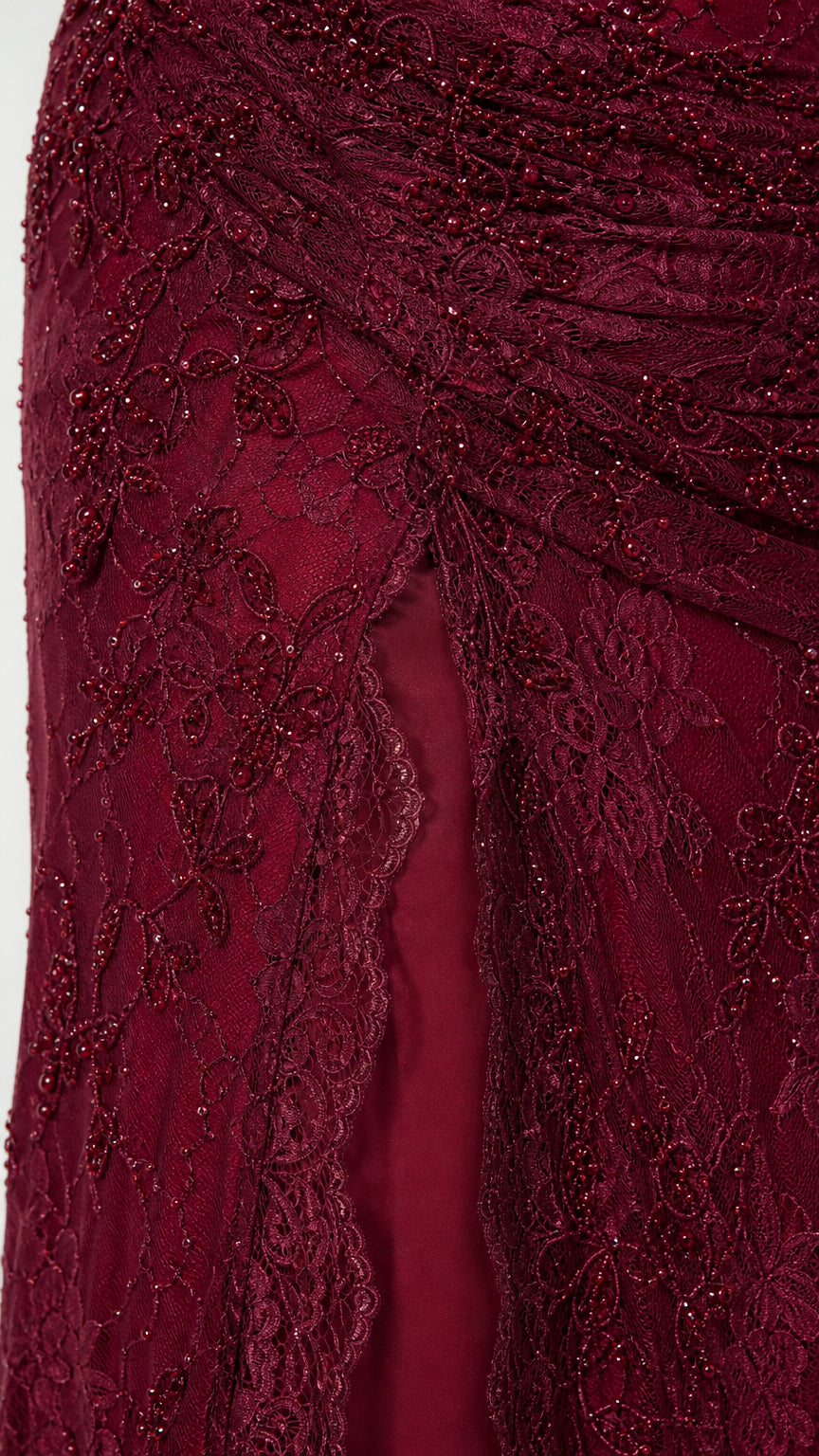 Close up of lace and bead detailing on the Burgundy evening dress skirt and slit