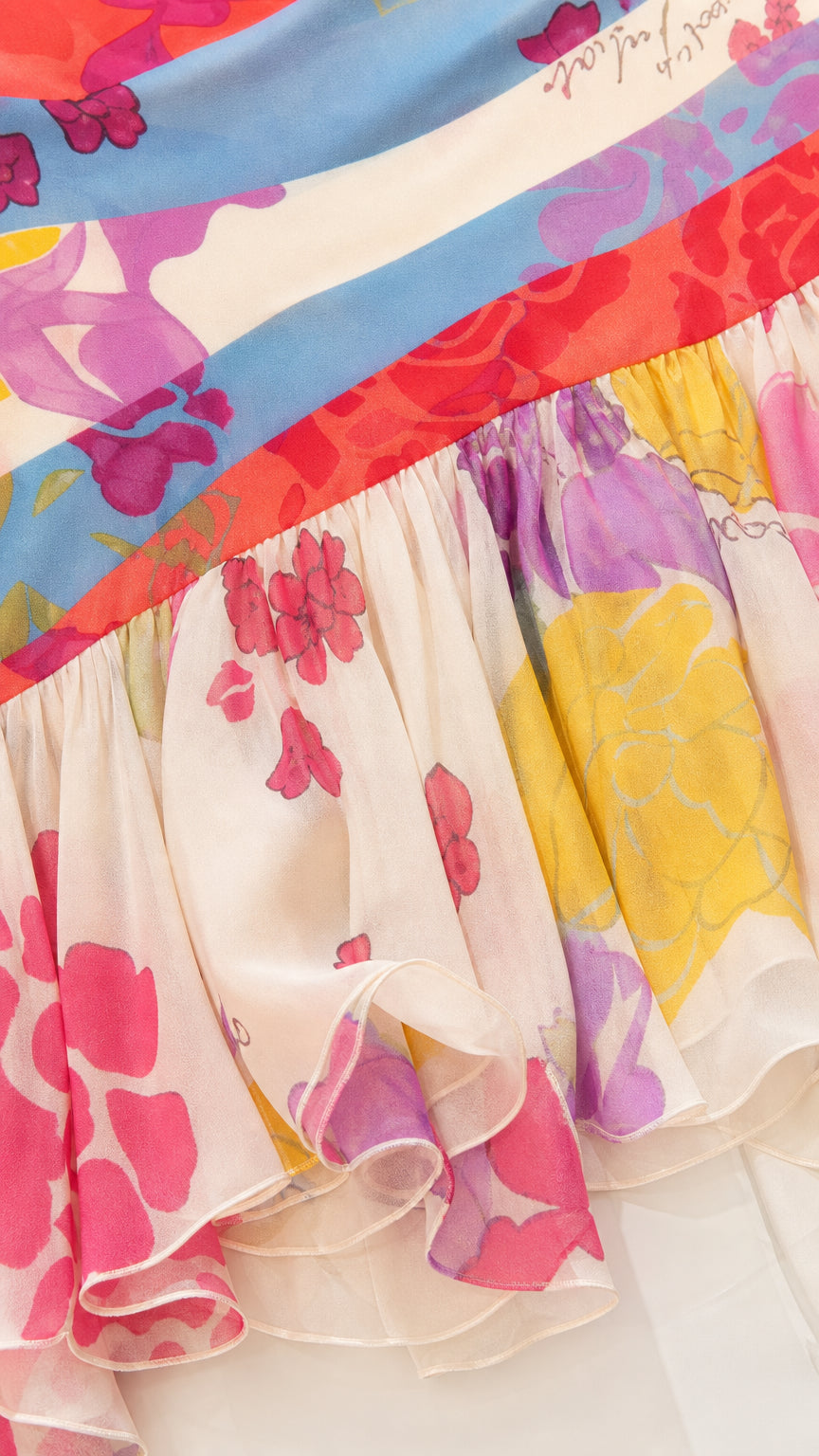 Close-up detail of tiered ruffle hem and diagonal floral colorblock chiffon fabric