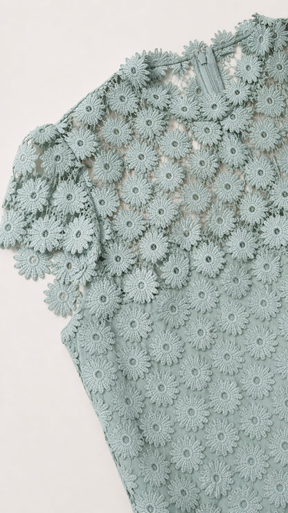 Close-up detail of sage green floral lace pattern and cap sleeve