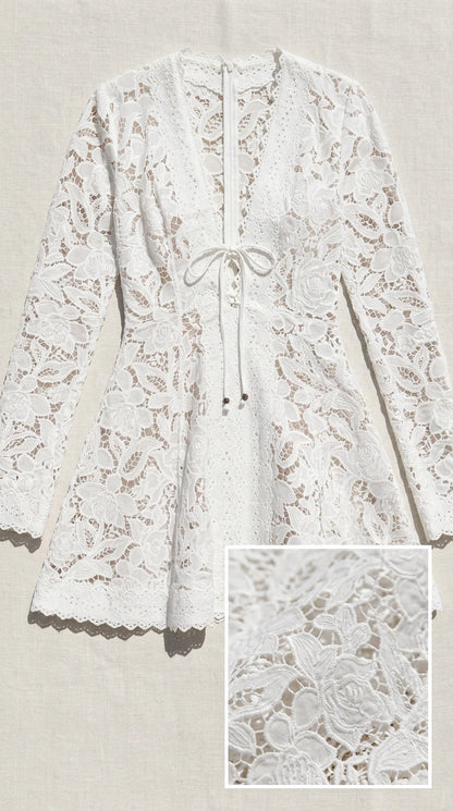 Flat lay of white lace dress showing fabric texture detail
