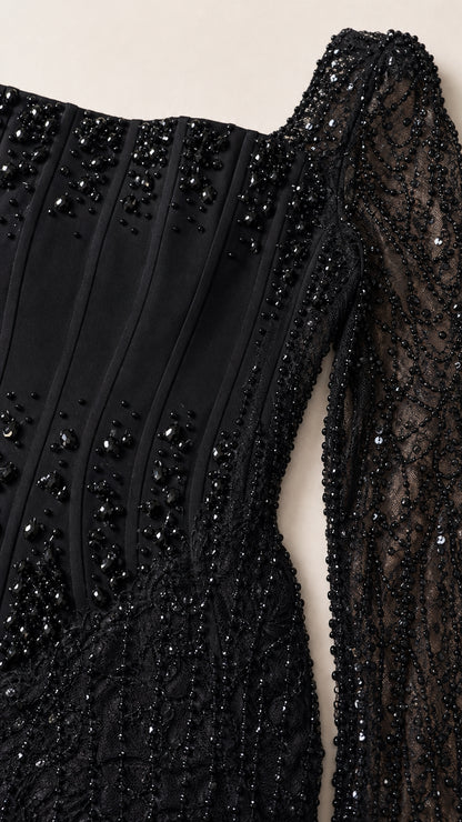 Close-up detail of black corset bodice with beaded lines and sequin mesh fabric