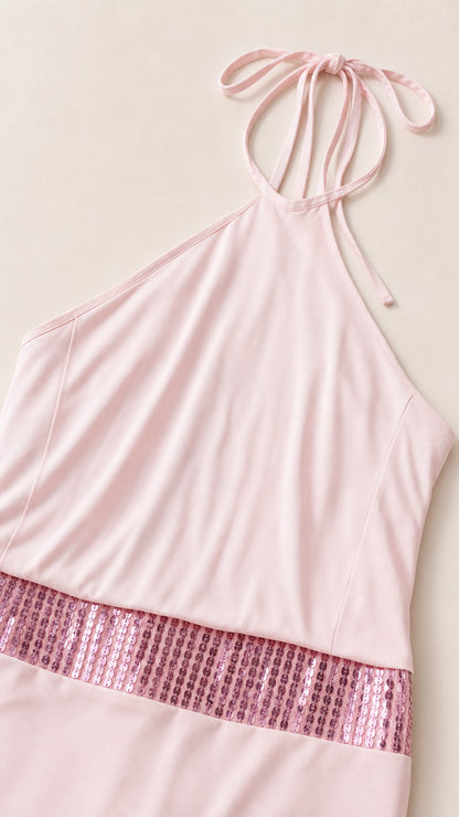 Close-up detail of halter straps and sequin waist panel on pink dress