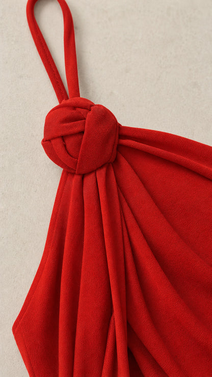 Close-up detail of the decorative shoulder knot and straps in red