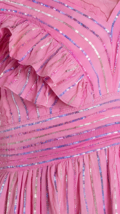 Close-up detail of ruffles and sequin stripe texture on pink dress