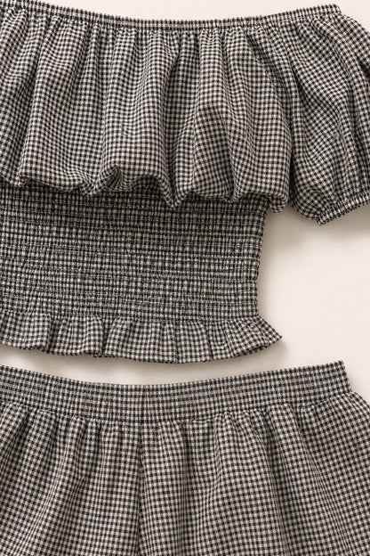Close-up of ruffled off-the-shoulder neckline and smocked top