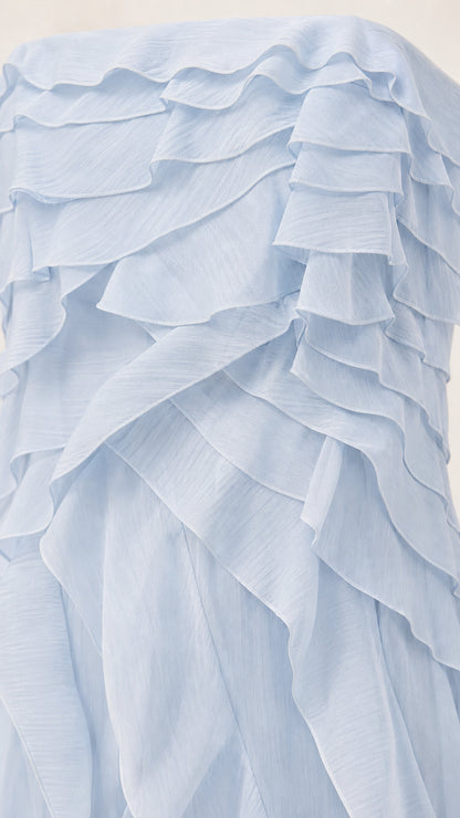 Close-up detail of cascading textured ruffles in light blue