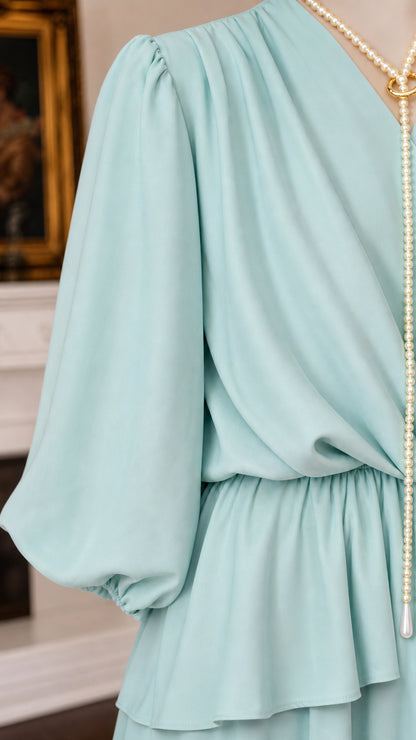 Close-up of sleeve and layered bodice detail on mint green dress