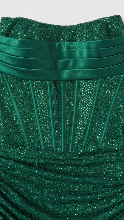 Close-up detail of the pleated bust and corset boning on the green glitter dress