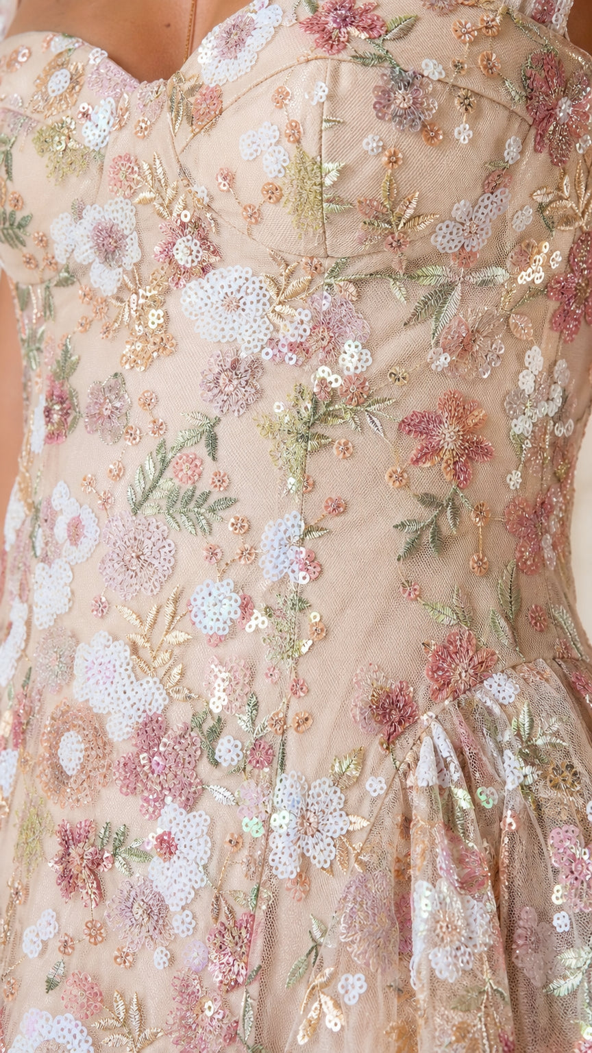 Close-up detail of floral embroidery and sequins on champagne dress
