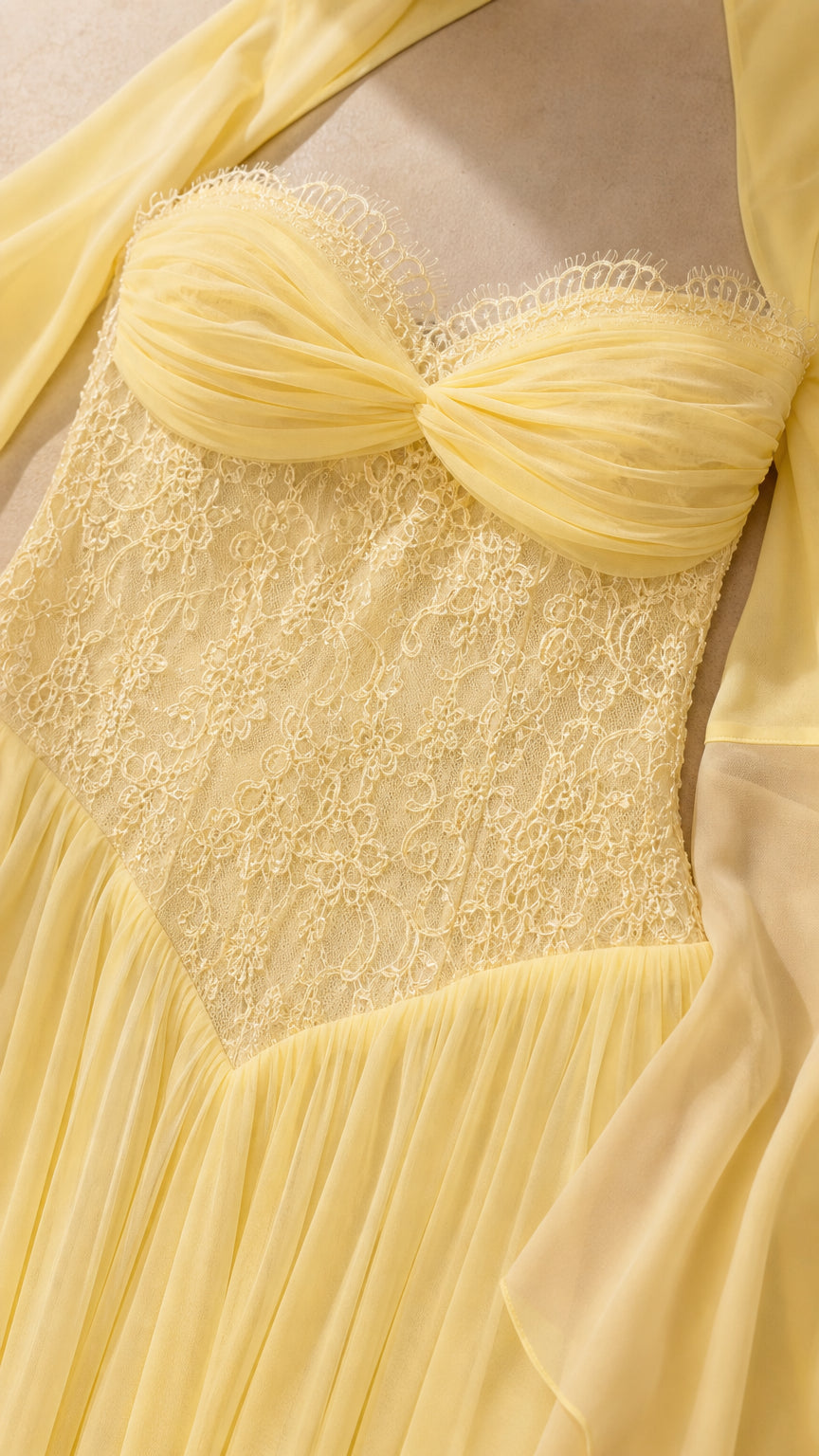 Close-up detail of pale yellow ruched sweetheart neckline and floral lace bodice