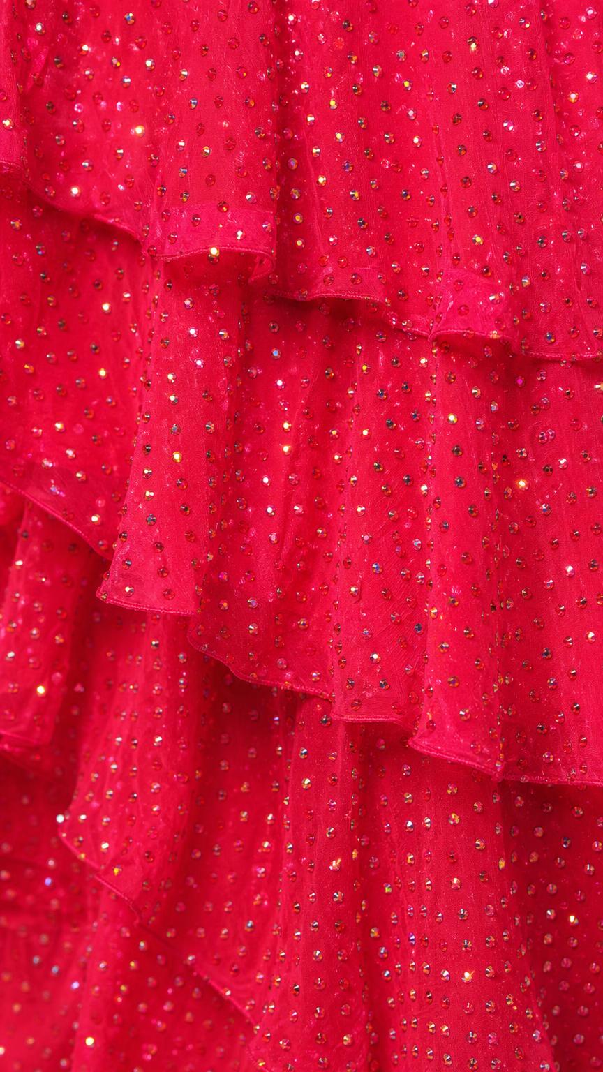 Close-up detail of fuchsia sequin fabric and tiered ruffles