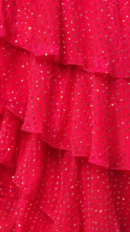 Close-up detail of fuchsia sequin fabric and tiered ruffles
