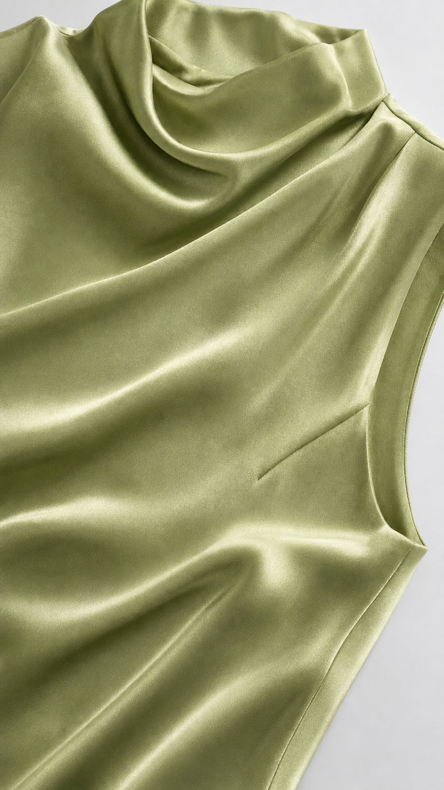 Close-up of smooth-looking sage satin fabric and mock neckline
