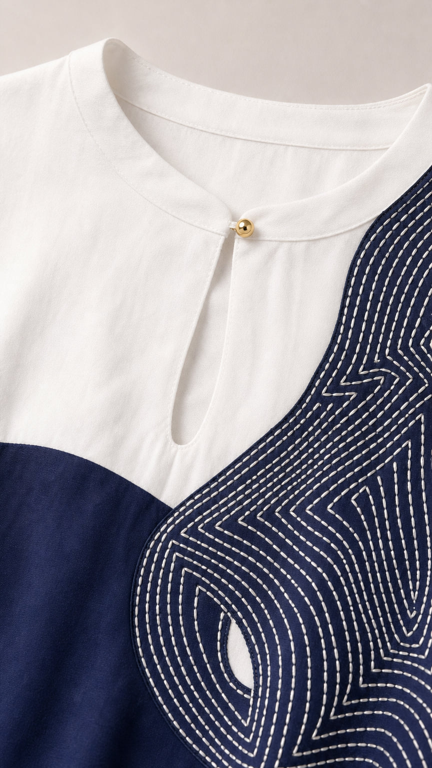 Close-up of neckline, keyhole, and contrast stitching detail