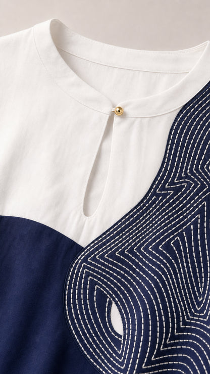 Close-up of neckline, keyhole, and contrast stitching detail