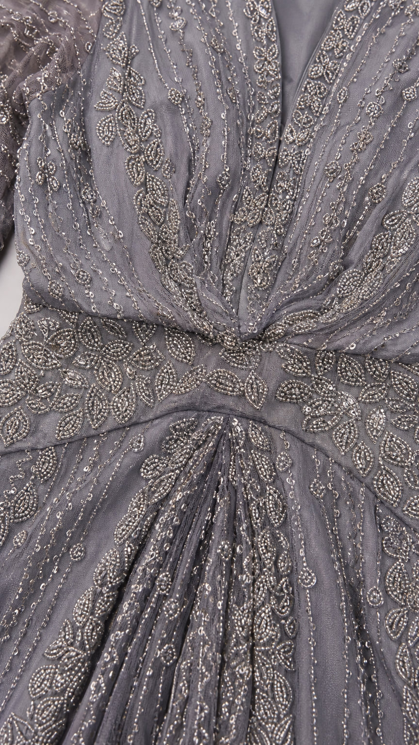 Close-up detail of intricate beading and sequin embroidery on slate grey bodice